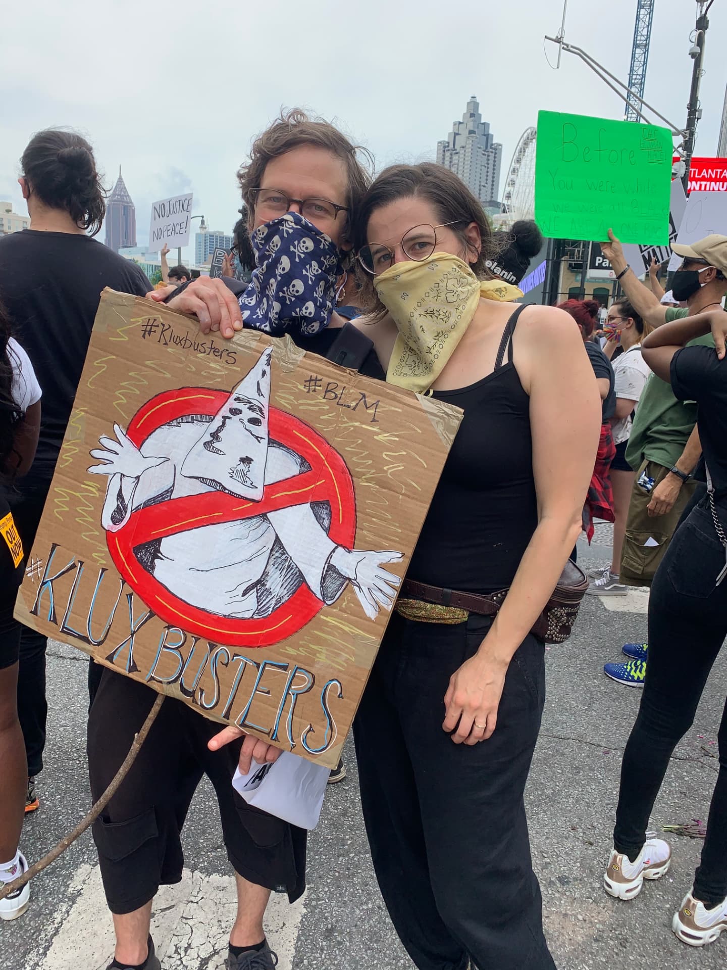 Disco Brian Davis and Lindsay Kovnat at a Black Lives Matter protest in downtown Atlanta holding a hand-drawn KluxBusters sign