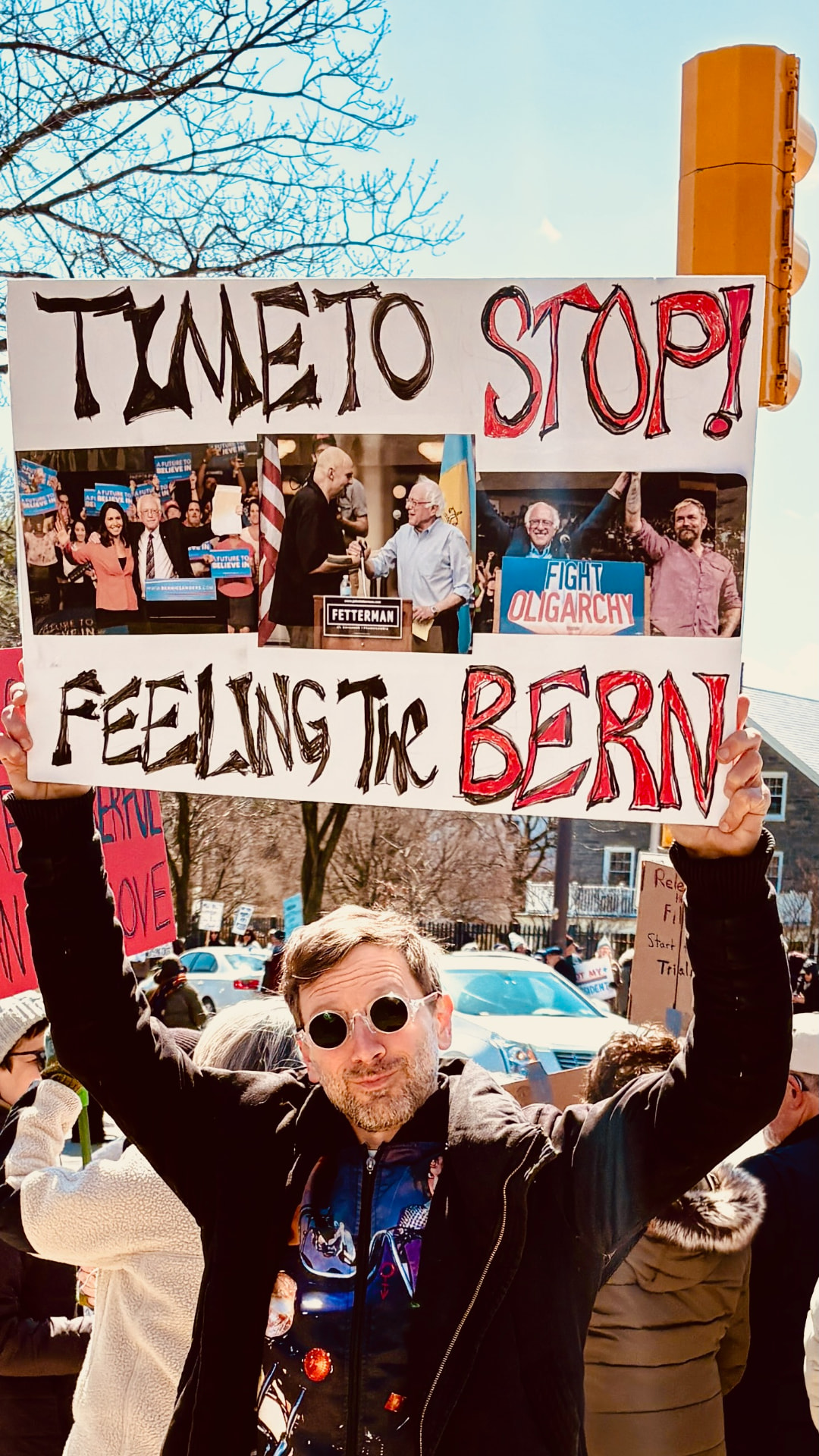 Disco Brian Davis at the No Kings march holding a hand-painted 'Time to Stop Feelin' the Bern' sign